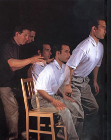 Strobe photograph of man rising from chair, guided by Alexander Teacher