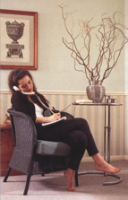 Woman leaning back on a chair while on the telephone