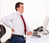Office worker at desk with back pain